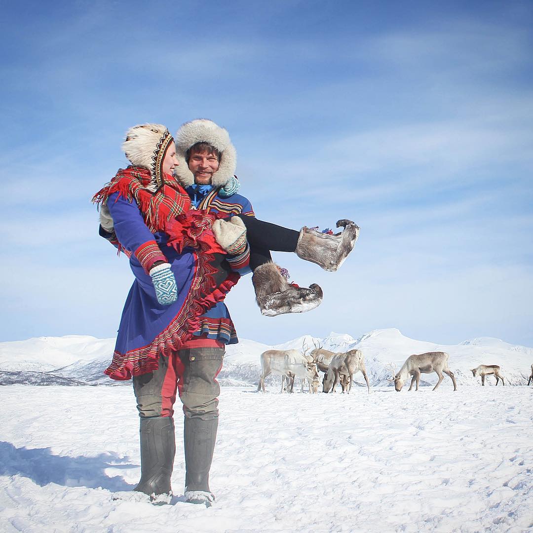 Johan Isak carrying Piia at our reindeer camp outside Tromsø